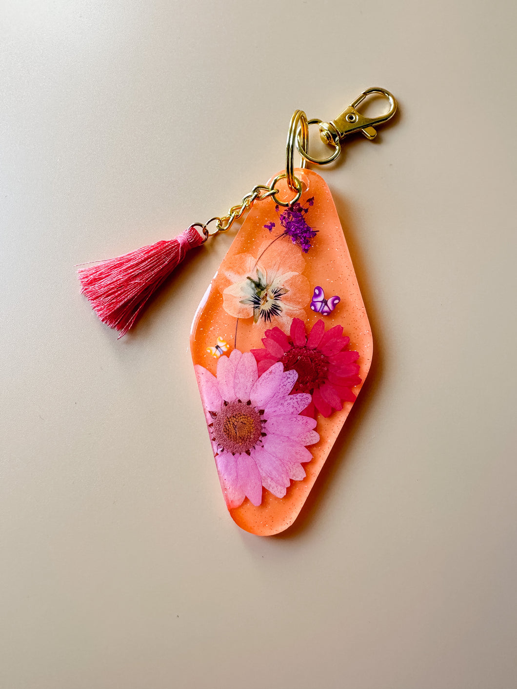 neon orange, pink, and purple dried floral keychain